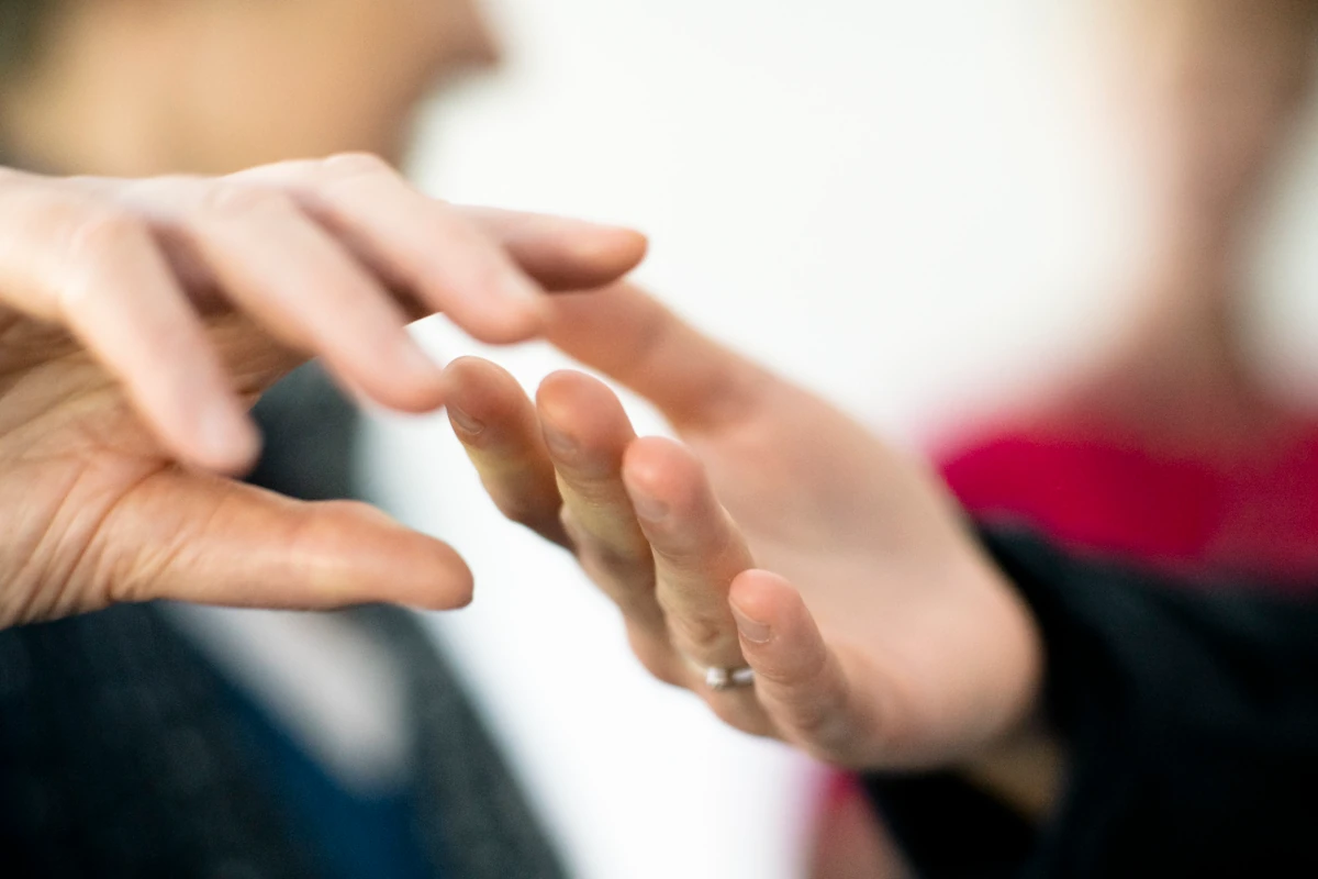 Hands making contact against out-of-focus background